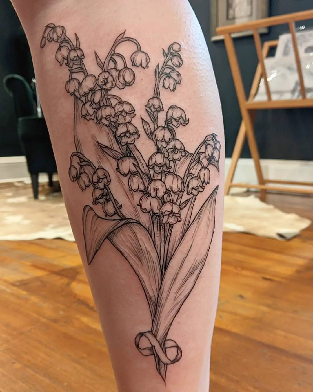 Illustrative Blackwork Lily of the Valley Calf Tattoo